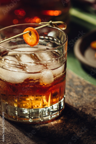 Whiskey with ice and kumquat photo