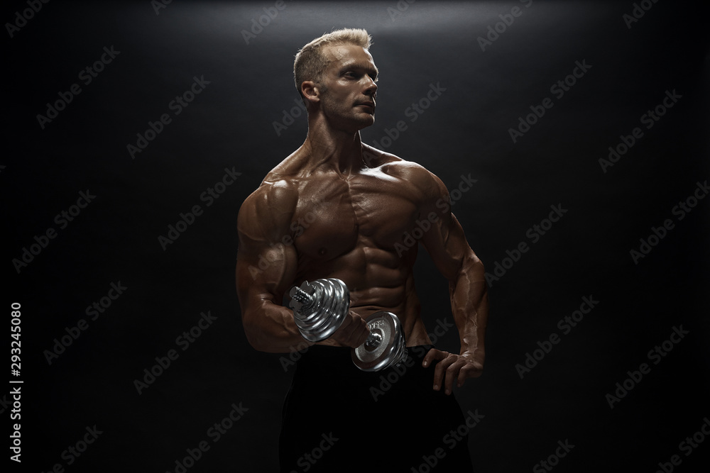 Naklejka premium Fitness model man posing in studio