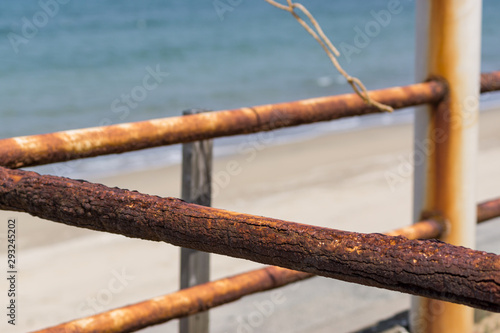 rusty fence on the beach