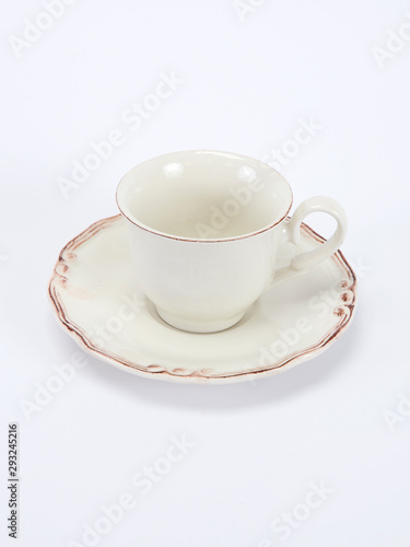 Empty white ceramic coffee or tea cup and saucer isolated on white background