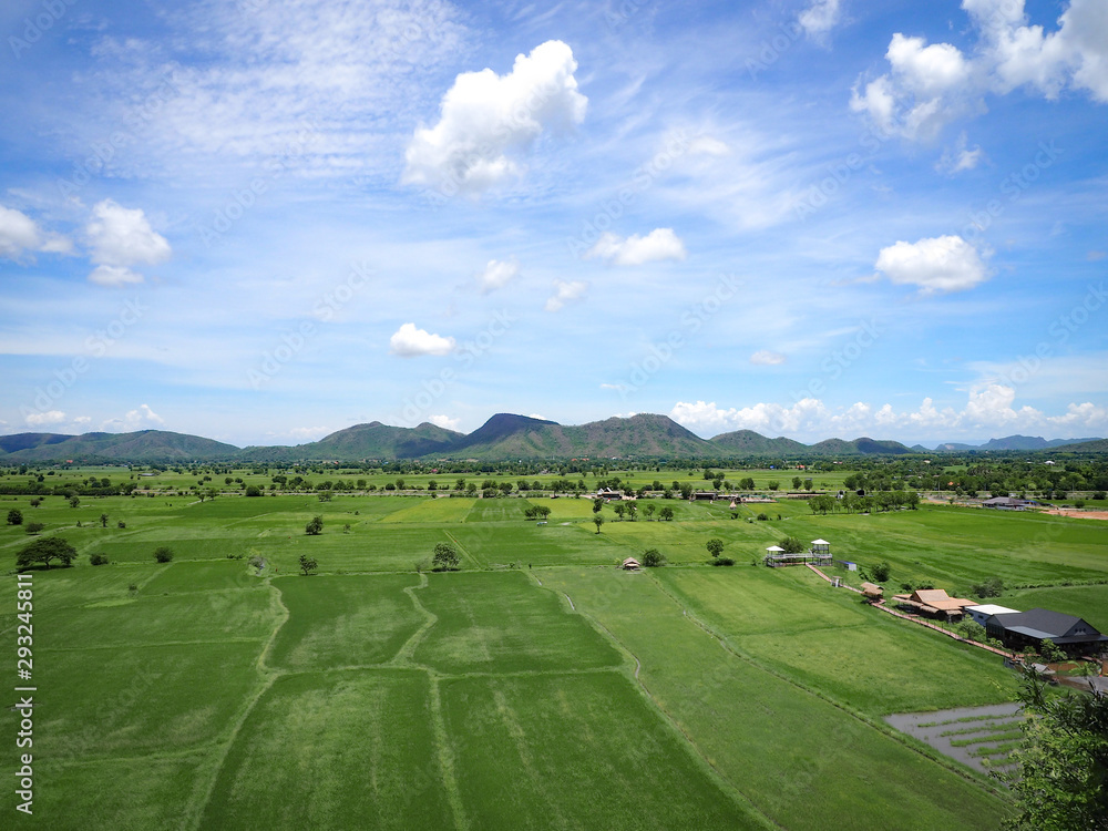 At Kanchanaburi Thailand back area Suea cave temple have large Vast green fields, mountain and beautiful sky.