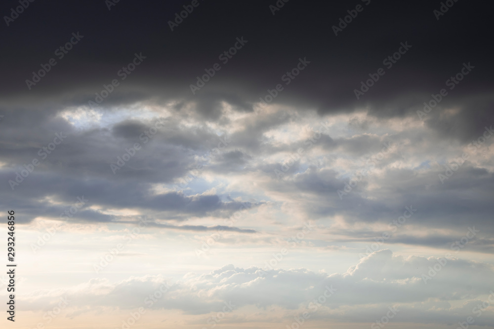 Dark thunder clouds on the blue sky. Abstract background with clouds on blue sky.