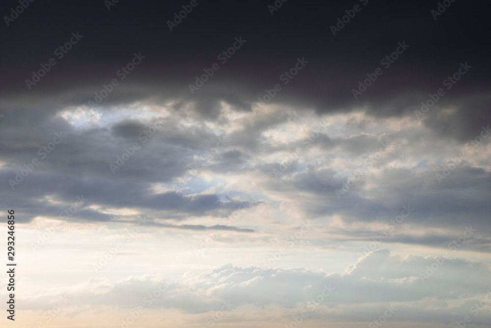 Dark thunder clouds on the blue sky. Abstract background with clouds on blue sky. Dark thunder clouds on the blue sky. Abstract background with clouds on blue sky.