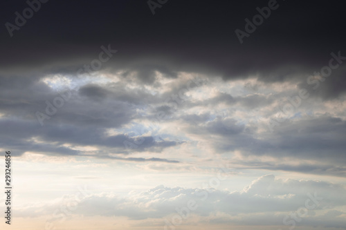 Dark thunder clouds on the blue sky. Abstract background with clouds on blue sky.