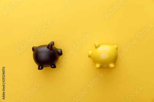 top view of piggy banks on yellow background photo