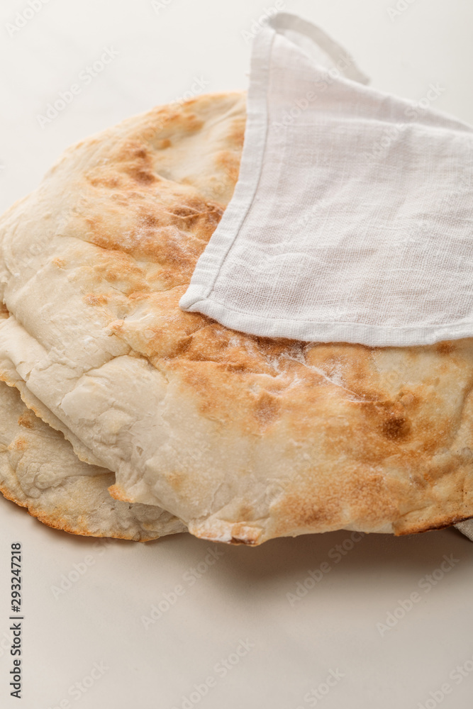 lavash bread covered with towel on white surface lavash bread covered with towel on white surface