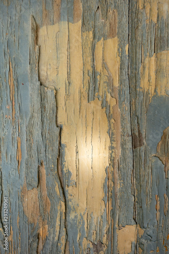 Old cracked paint on a gray wood panel. Creative vintage natural background.