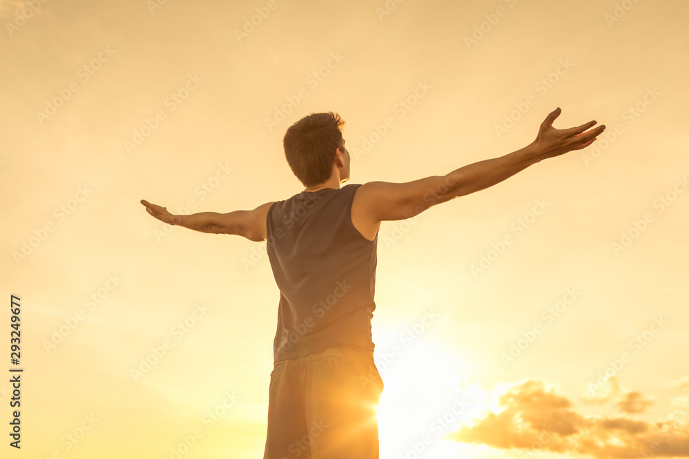 Success achievement accomplishment and motivation concept with man sunset silhouette celebrating arms up raised outstretched outdoors in nature 	 - obrazy, fototapety, plakaty 