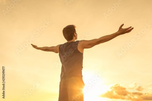 Success achievement accomplishment and motivation concept with man sunset silhouette celebrating arms up raised outstretched outdoors in nature 