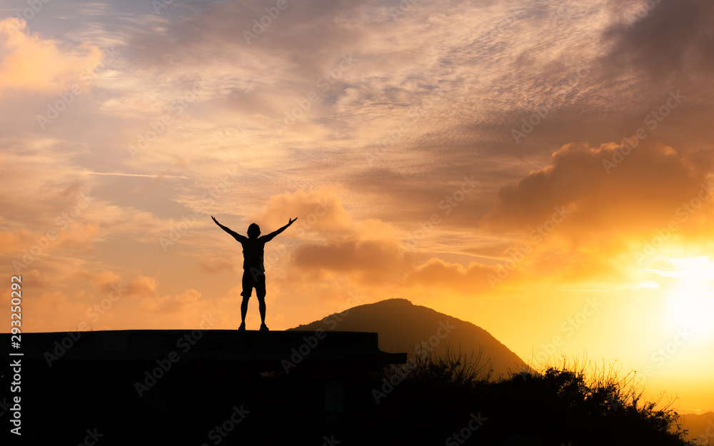 Success achievement accomplishment and motivation concept with man sunset silhouette celebrating arms up raised outstretched trekking climbing outdoors in nature 	