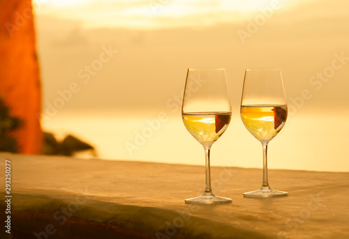 Two wine glasses and beautiful ocean view from hotel balconey  photo