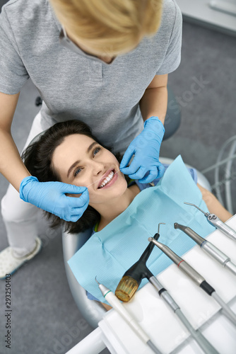 Pretty woman s teeth cleaning in dental clinic