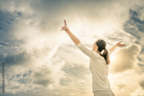 Woman feeling free and happy looking up to the sky 
