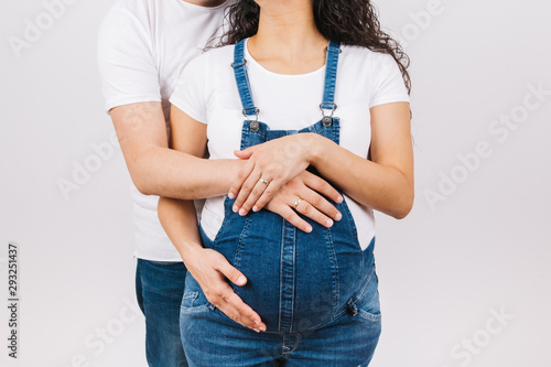 Cropped image of beautiful pregnant woman and her handsome husband holding