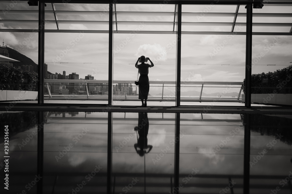 Woman stand in front of windows Woman stand in front of windows