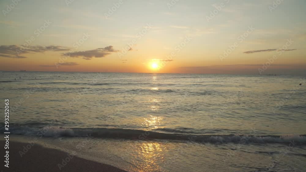 Sunset view from beach, waves crashing on sand beach. Camera tilt Sunset view from beach, waves crashing on sand beach. Camera tilt