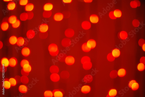 Schilderij op canvas Red-orange trendy festive background of blurry Christmas lights