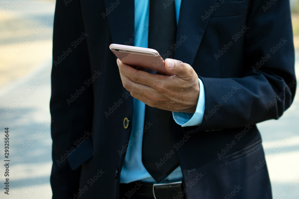 Businessman holding using mobile smart phone Businessman holding using mobile smart phone