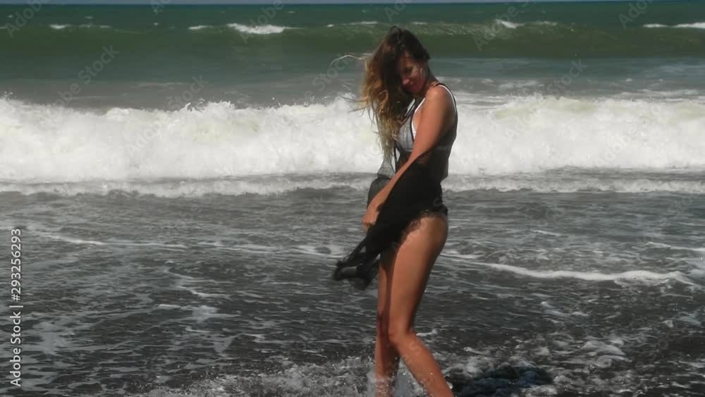 Beautiful young woman in white bikini and light black summer dress. Fitness healthy active living. Sport and travel. Weight loss and body image concept. Girl with perfect fit body on tropical beach. Beautiful young woman in white bikini and light black summer dress. Fitness healthy active living. Sport and travel. Weight loss and body image concept. Girl with perfect fit body on tropical beach.