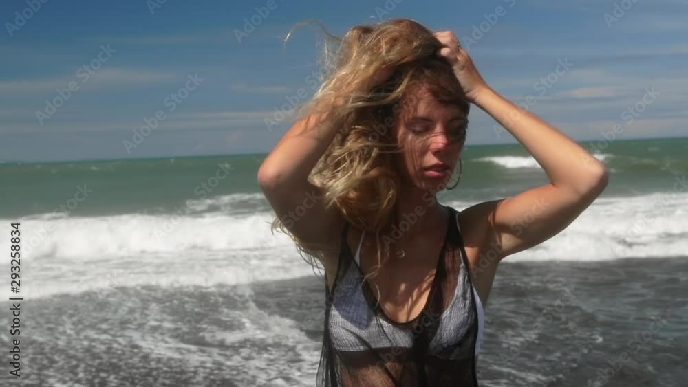 Portrait of beautiful young woman in white bikini and light black summer dress. Concept of fitness healthy active living. Slow motion. Sport and travel. Happy smiling lady playful having fun. Portrait of beautiful young woman in white bikini and light black summer dress. Concept of fitness healthy active living. Slow motion. Sport and travel. Happy smiling lady playful having fun.