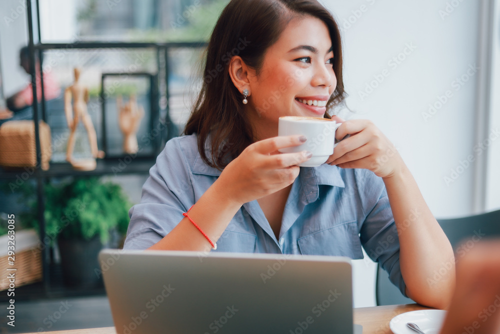 Asian woman in blue shirt in cafe drinking coffee and talking with boy friend smile and happy face Asian woman in blue shirt in cafe drinking coffee and talking with boy friend smile and happy face