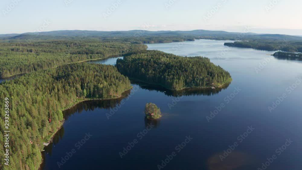 Panoramic drone shot of crystal clear lake in Sweden inland surrounded by deep forest landscape Panoramic drone shot of crystal clear lake in Sweden inland surrounded by deep forest landscape
