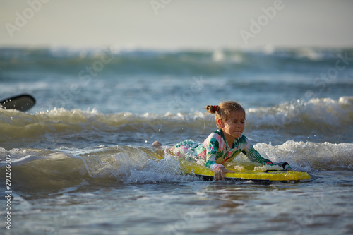 girl with his bodyboard walking into the ocean