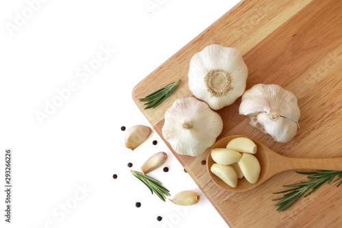 Garlic with rosemary and peppercorn on wooden. Isolated on white background. Top view. Flat lay pattern