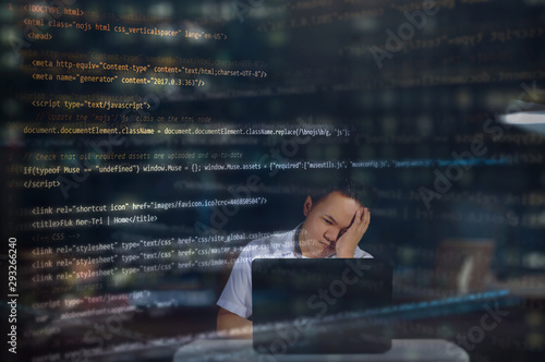 An IT student almost falling asleep at night while writing codes in building a website with random HTML codes surrounding the web designer. Night scenery.   photo