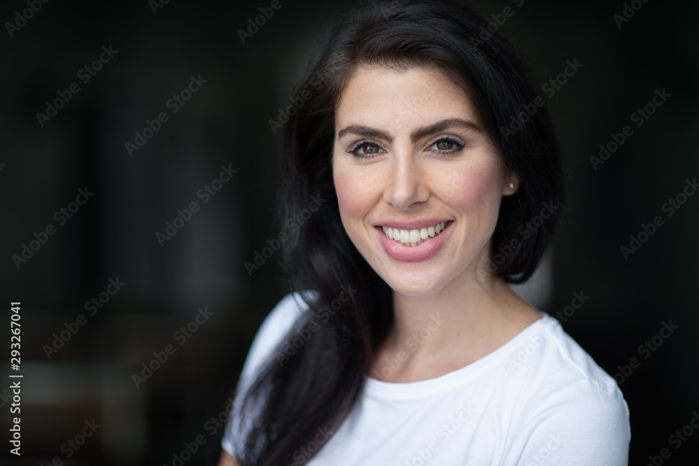 Close up portrait of a young happy woman looking cheerful and smiling Close up portrait of a young happy woman looking cheerful and smiling