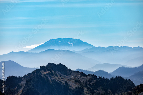 Beautiful layers of misty mountains with Mt. St. Helens in the distance and Eagle Peak in the foreground as seen from Mt. Rainier National Park in Washington state