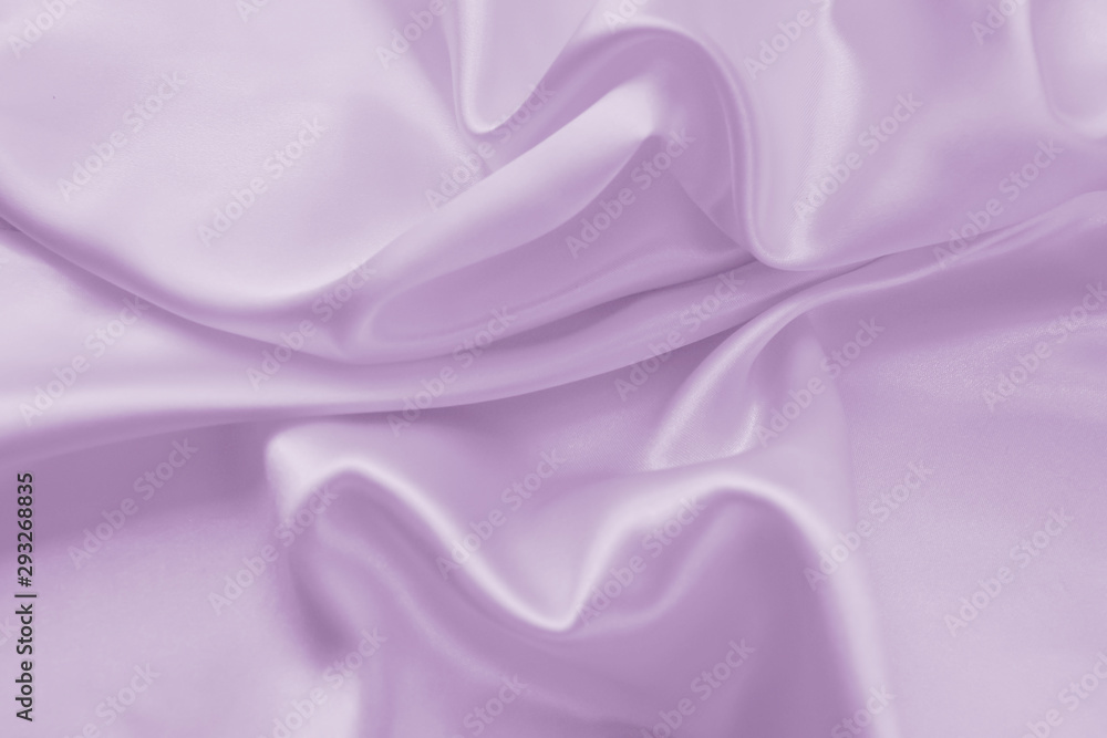 Delicate satin draped fabric of lilac color texture for festive backgrounds Delicate satin draped fabric of lilac color texture for festive backgrounds