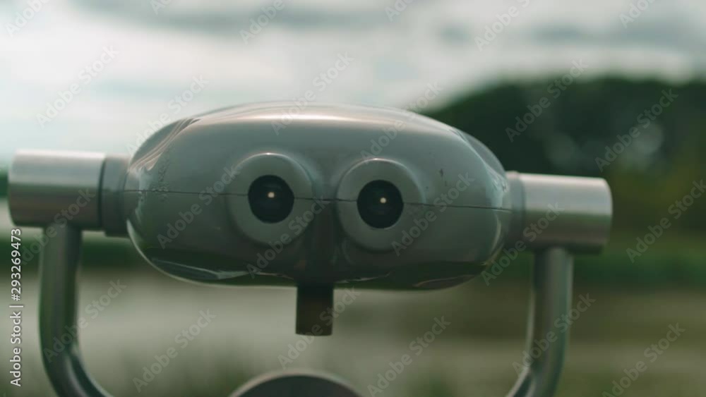 Push in on a towerviewer pointed at a forested hill in the background Push in on a towerviewer pointed at a forested hill in the background