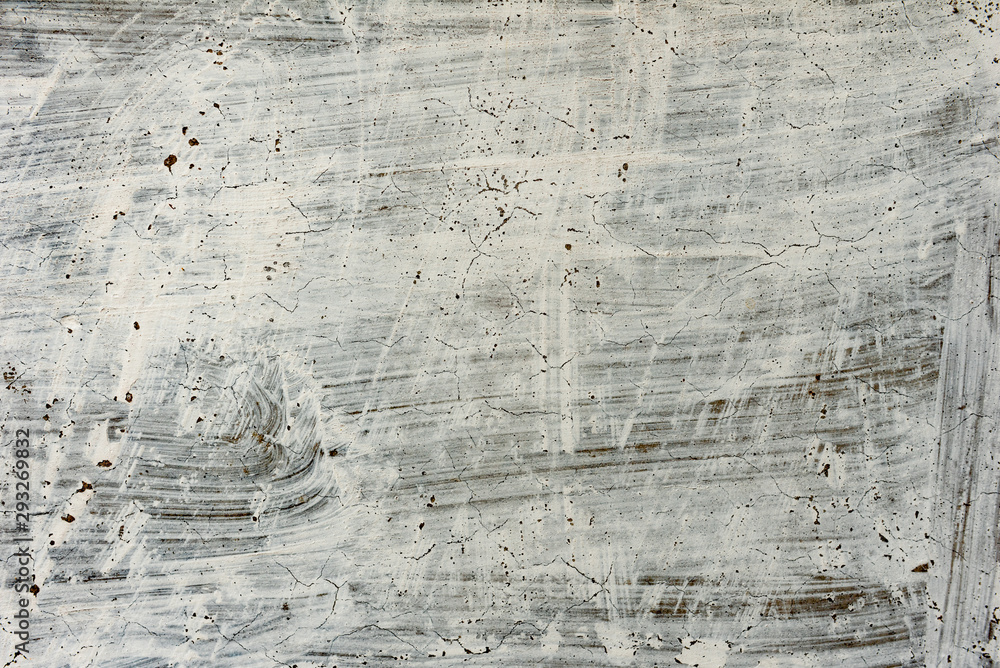Fototapeta premium Texture of a concrete wall with cracks and scratches which can be used as a background