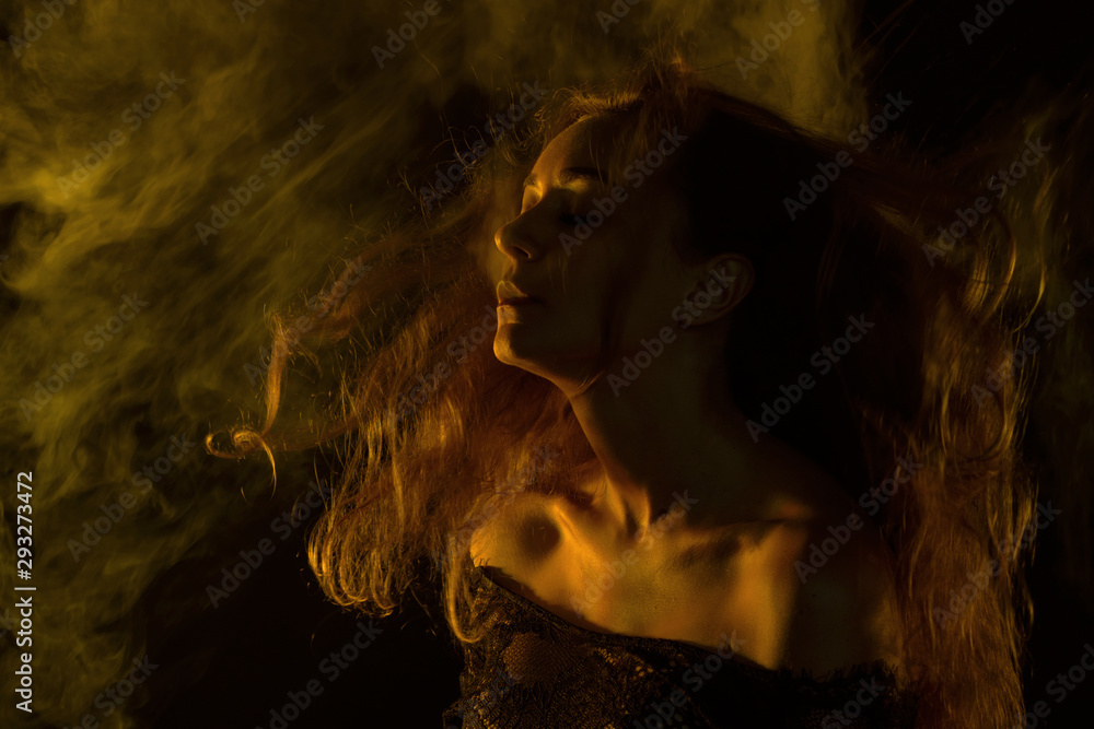 Beautiful woman with long hair in colors smoke