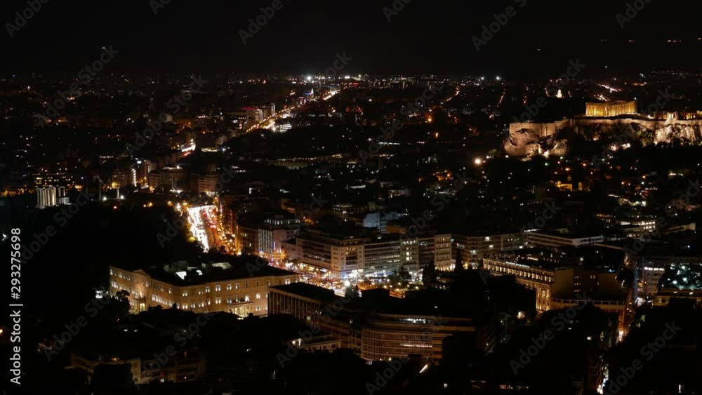Aerial Night Timelapse of Athens downtown. Wide angle panorama with residential high-rise and small buildings. Traffic lights blurred on road. Aerial Night Timelapse of Athens downtown. Wide angle panorama with residential high-rise and small buildings. Traffic lights blurred on road.