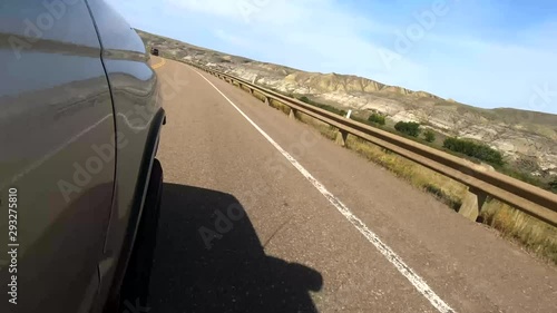 Driving down a highway in the country on a sunny day with a view of the mountains. photo