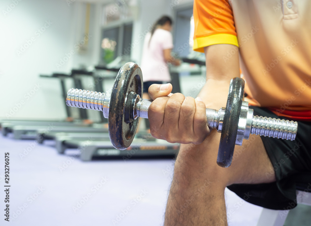 Close up hand holding dumbbell in fitness. Close up hand holding dumbbell in fitness.