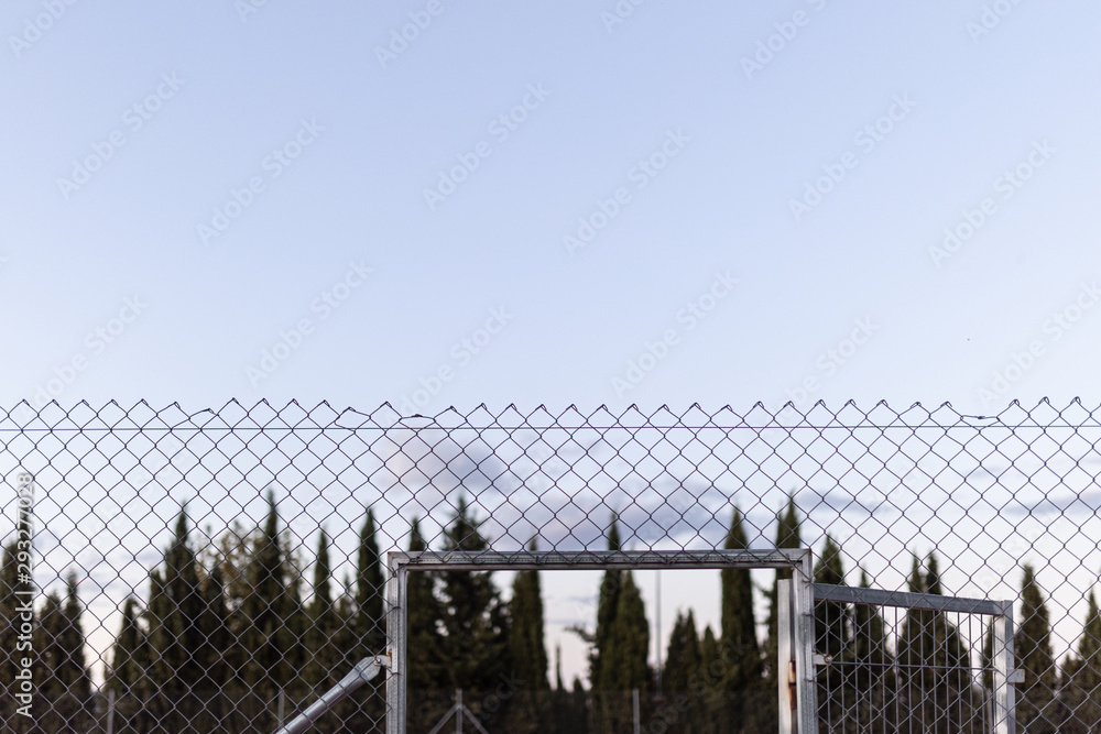 wire fence at sunset with unfocused background wire fence at sunset with unfocused background