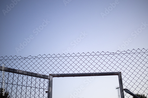wire fence at sunset with unfocused background