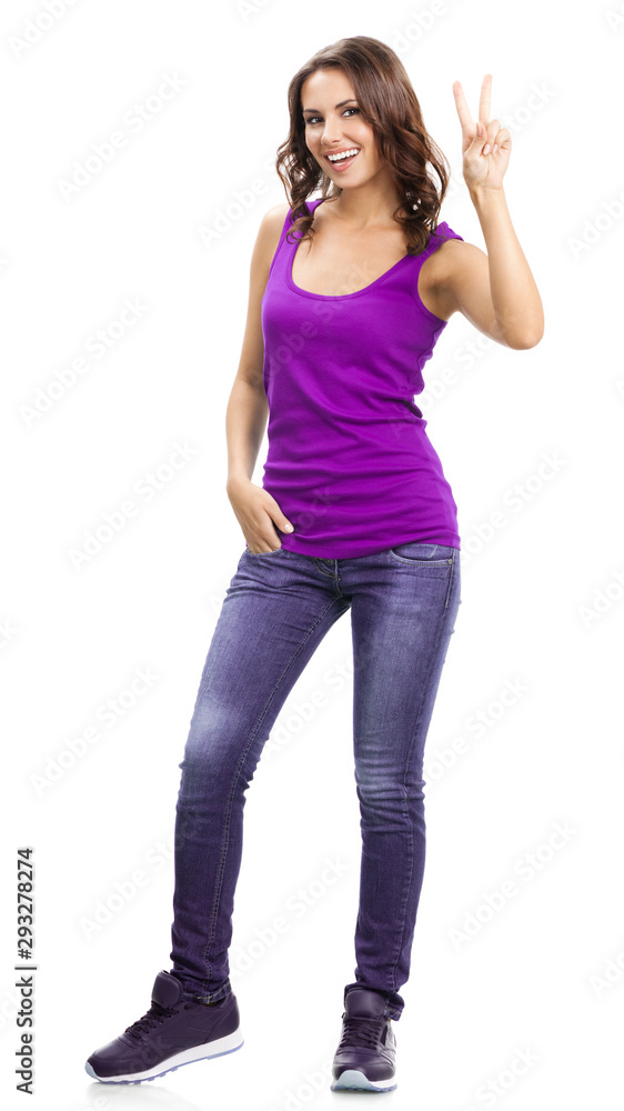 Full body portrait picture of happy smiling beautiful young brunette woman in casual smart lilac clothing, showing two fingers or victory gesture, isolated over white background Full body portrait picture of happy smiling beautiful young brunette woman in casual smart lilac clothing, showing two fingers or victory gesture, isolated over white background