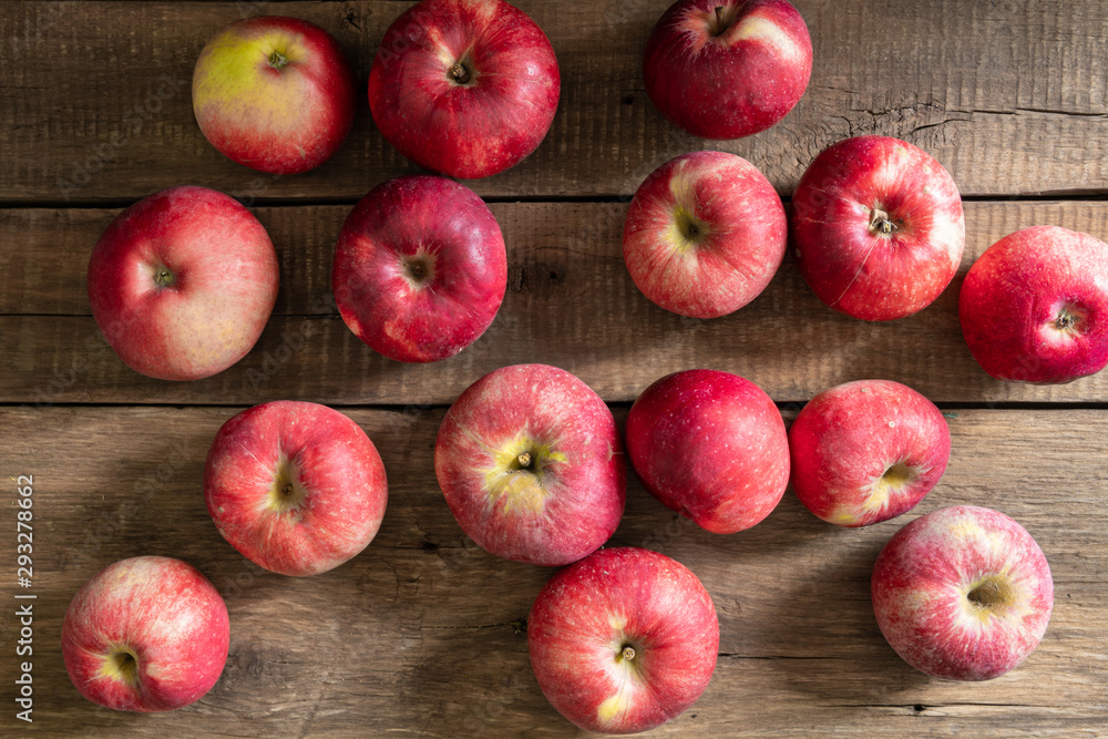 Apples lie on wooden planks, ripe red fruits Apples lie on wooden planks, ripe red fruits