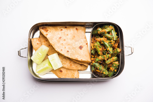 Lunch Box / Tiffin for Indian kids, includes beans vegetable sabzi with roti or chapati, selective focus photo