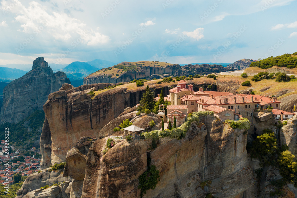 Kalampaka city, Greece aerial view drone on panorama of mountain range. View of the cliffs of Meteora and the monasteries of Meteora. Many ancient Orthodox monasteries summer