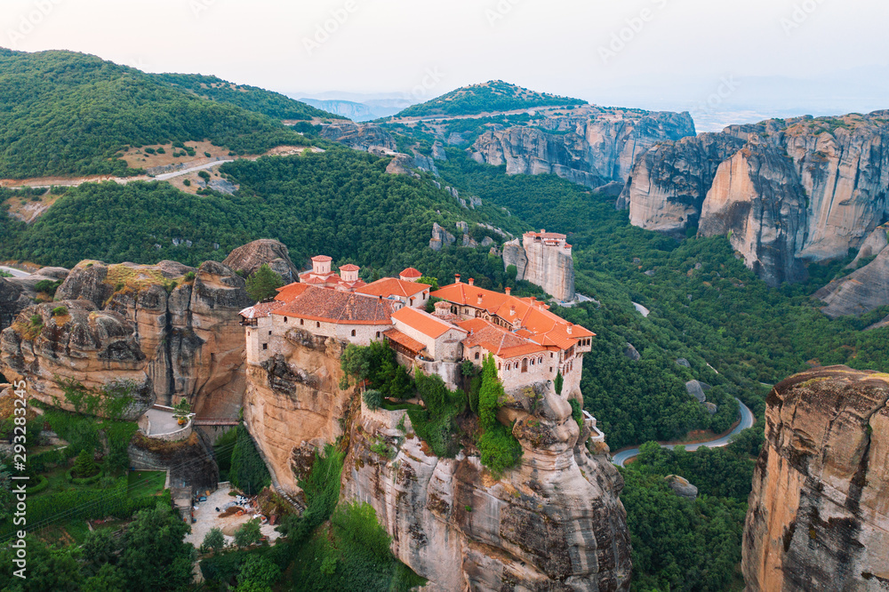 Aerial view of a slide from a drone on a panorama of a mountain range. Kalampaka city, Greece. View of the cliffs of Meteora and the monasteries of Meteora. Many ancient Orthodox monasteries summer Aerial view of a slide from a drone on a panorama of a mountain range. Kalampaka city, Greece. View of the cliffs of Meteora and the monasteries of Meteora. Many ancient Orthodox monasteries summer