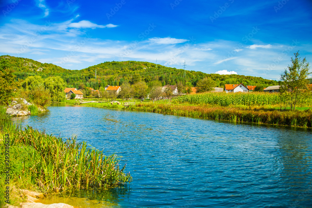 Croatia, countryside rural landscape, village by Gacka river in region of Lika