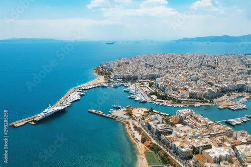 Piraeus, Greece aerial view drone on panorama of buildings of residential and administrative buildings of the city in summer on sunny day. Roof plan aerial view of the blue sea. Front view © marina_larina