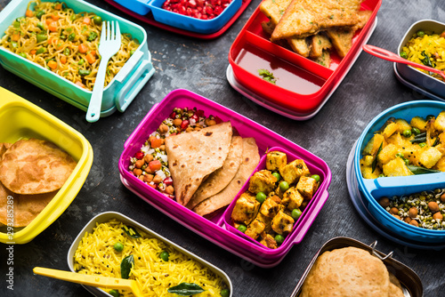 group of Lunch Box / Tiffin for Indian kids, showing variety or multiple option or combination of healthy food for your school going children photo
