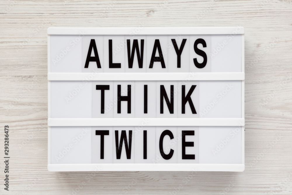 'Always think twice' words on a lightbox on a white wooden surface, top view. Overhead, from above, flat lay. 'Always think twice' words on a lightbox on a white wooden surface, top view. Overhead, from above, flat lay.