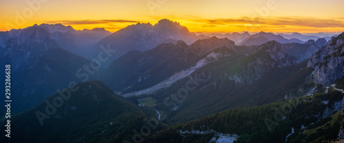 Panorama of the Julian Alps at sunset from the Mangart peak, the Triglav peak visible in the central part of the frame